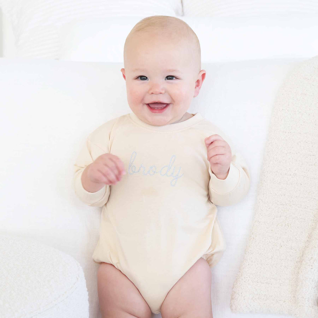 personalized long sleeve bubble romper for babies and toddlers with light blue thread 