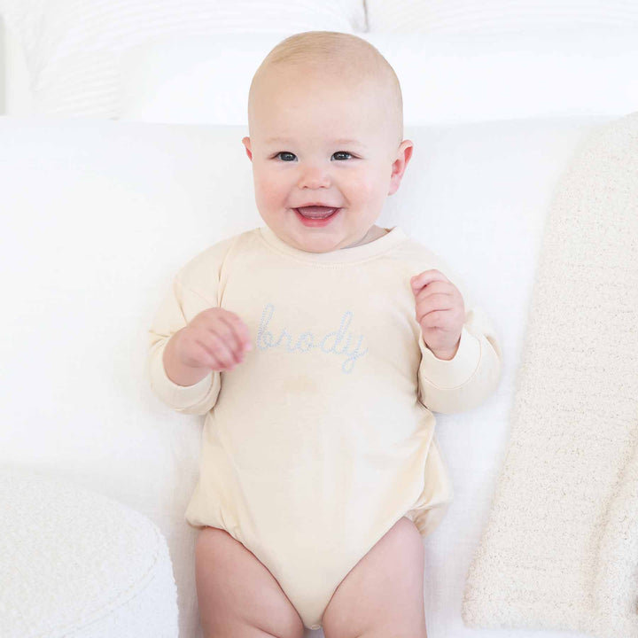 personalized long sleeve bubble romper for babies and toddlers with light blue thread 
