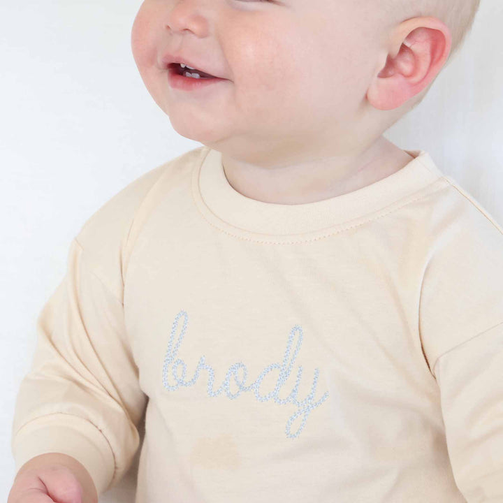 light blue thread name embroidered long sleeve bubble romper for babies 