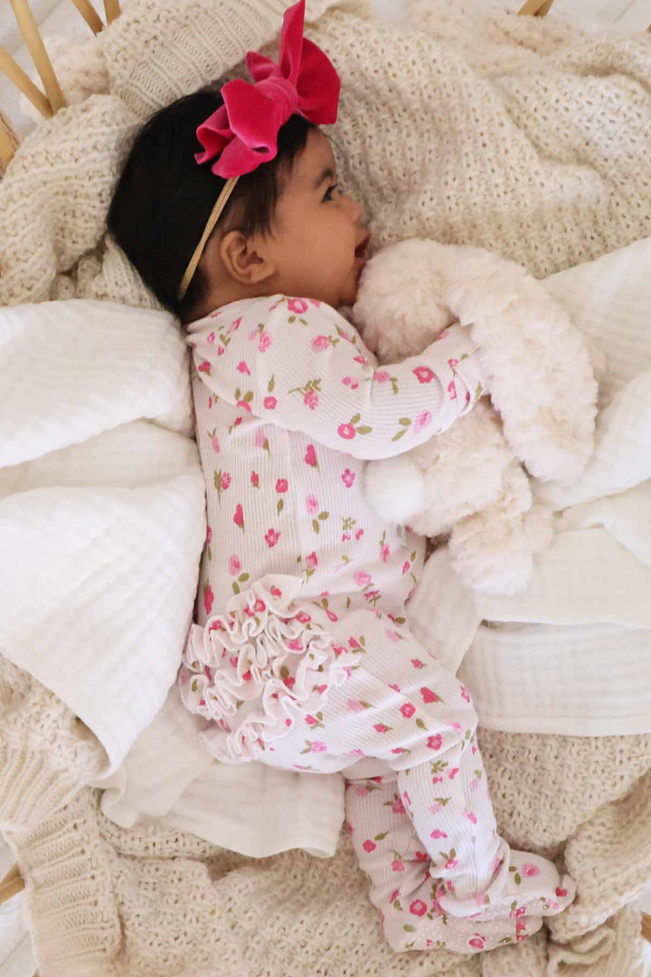 pink floral ruffle bottom footie for babies 