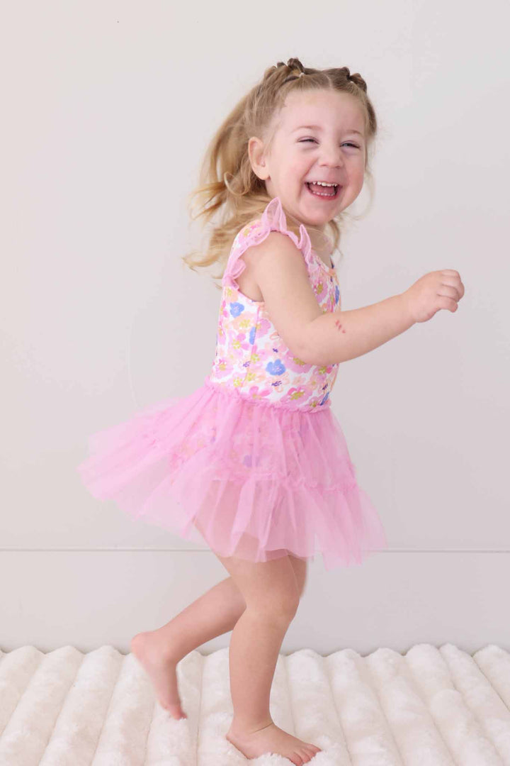 girl running wearing petal parade tulle skirt leotard