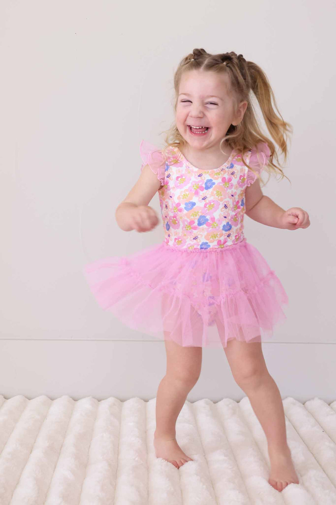 laughing girl wearing spring floral tulle skirt leotard