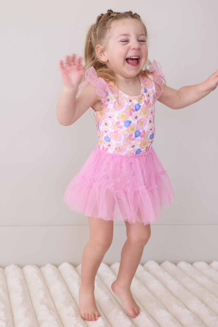 jumping girl in petal parade leotard