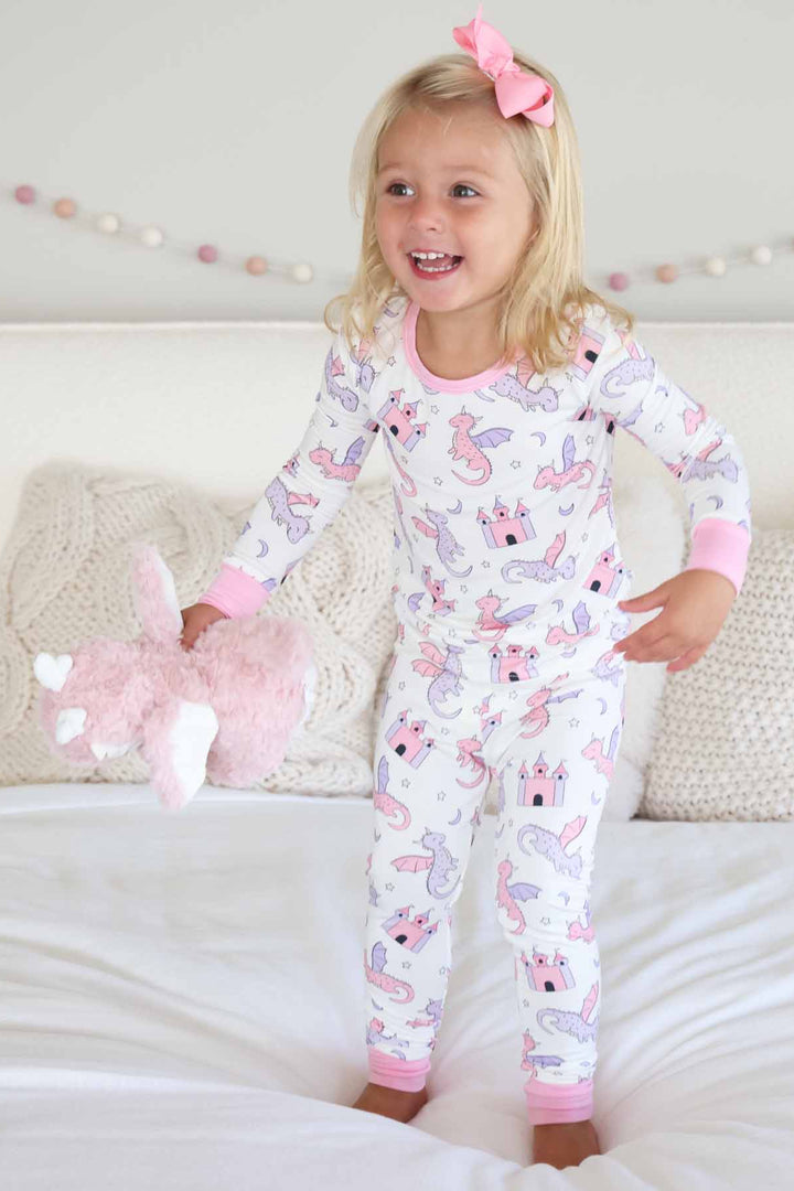 long sleeve and pants two piece pajama set for girls with pink dragon stuffed animal 
