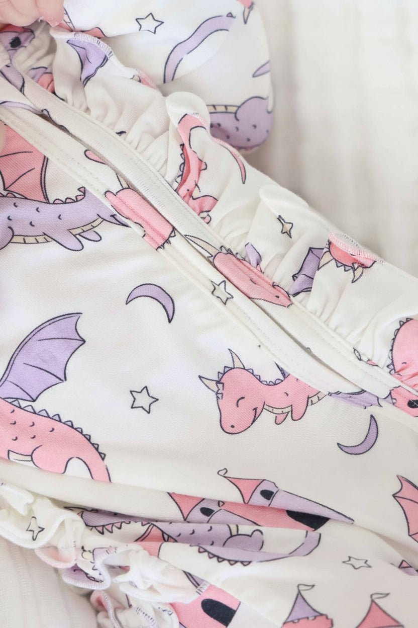 pink dragon adventure ruffle bottom zipper footie for baby girls 