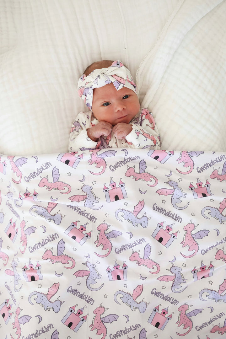 pink and purple dragon and castle personalized swaddle blanket for girls