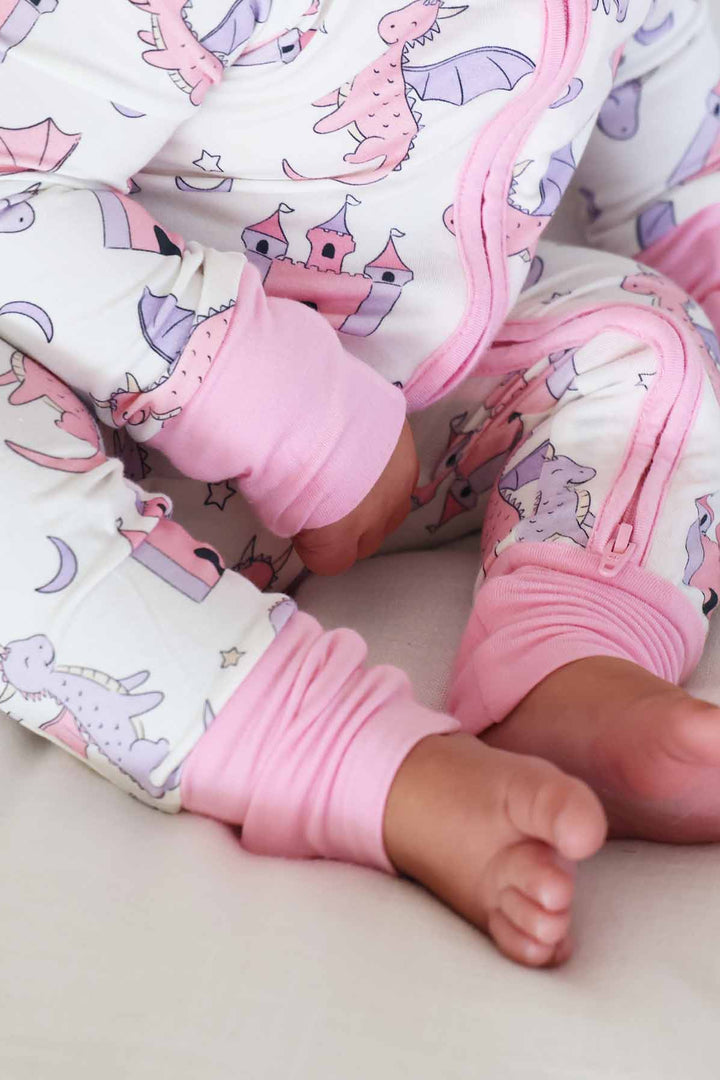 pink trim dragon adventure dragon and castle zip romper pajama for baby and toddler girls 