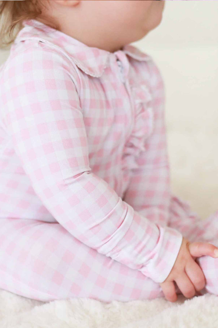 newborn pink gingham print footie pajamas with ruffles