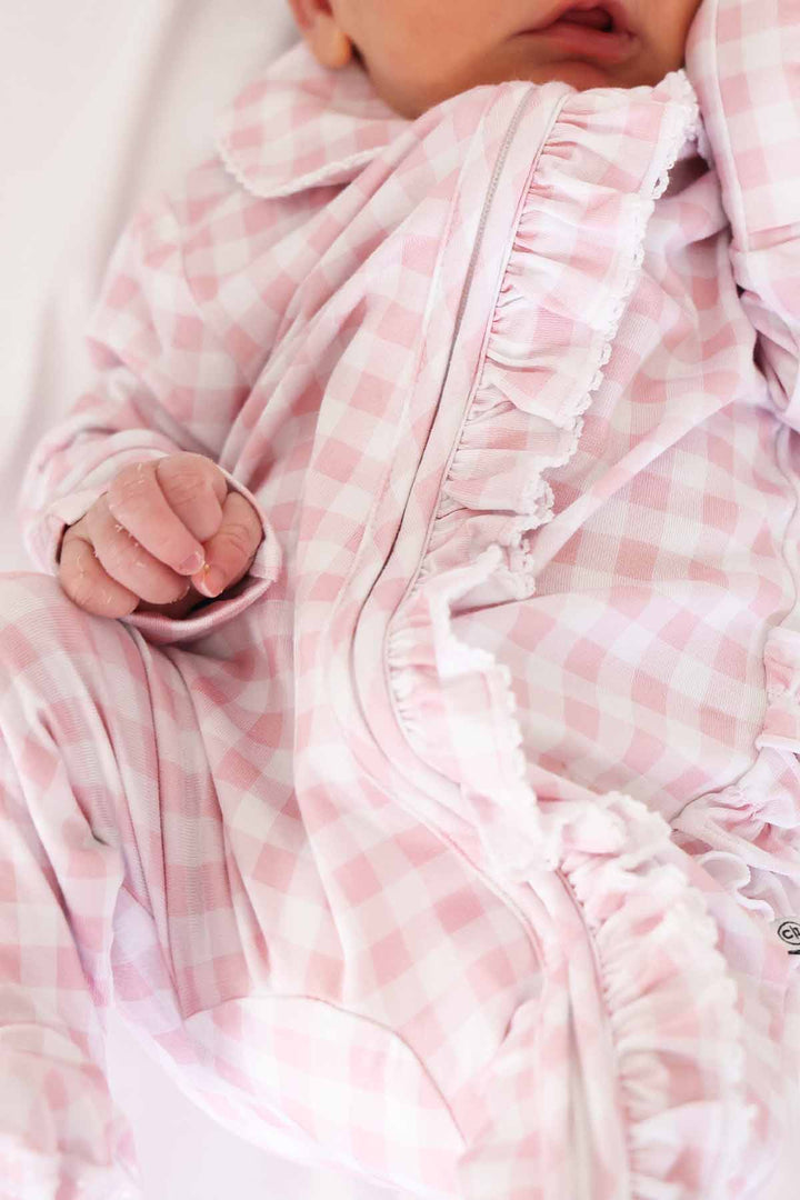 newborn pink gingham print footie pajamas with ruffles