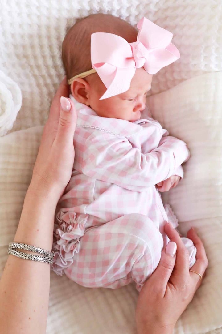 newborn pink gingham print footie pajamas with ruffles and lace trim