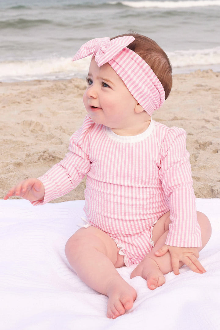 adorable pink seersucker rash guard swimsuit with ruffle detail baby girls