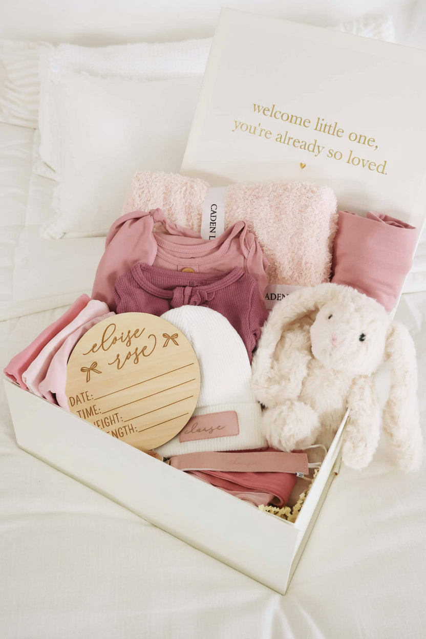 baby shower gift bundle for girls with pink 2pc waffle, zipper footie, knot gown, wood  stats, swaddles, bottle labels, burps, socks, paci clip, beanie, lovey, blanket, hooded towel, hair brush, bunny stuffed animal