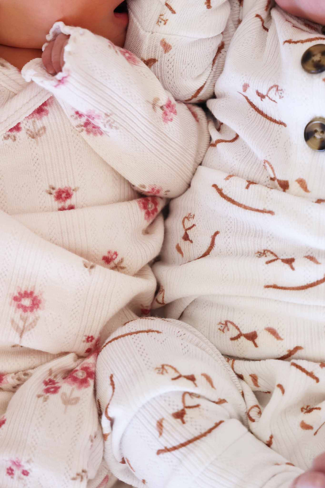 closeup of pointelle two piece crossover sets for babies 