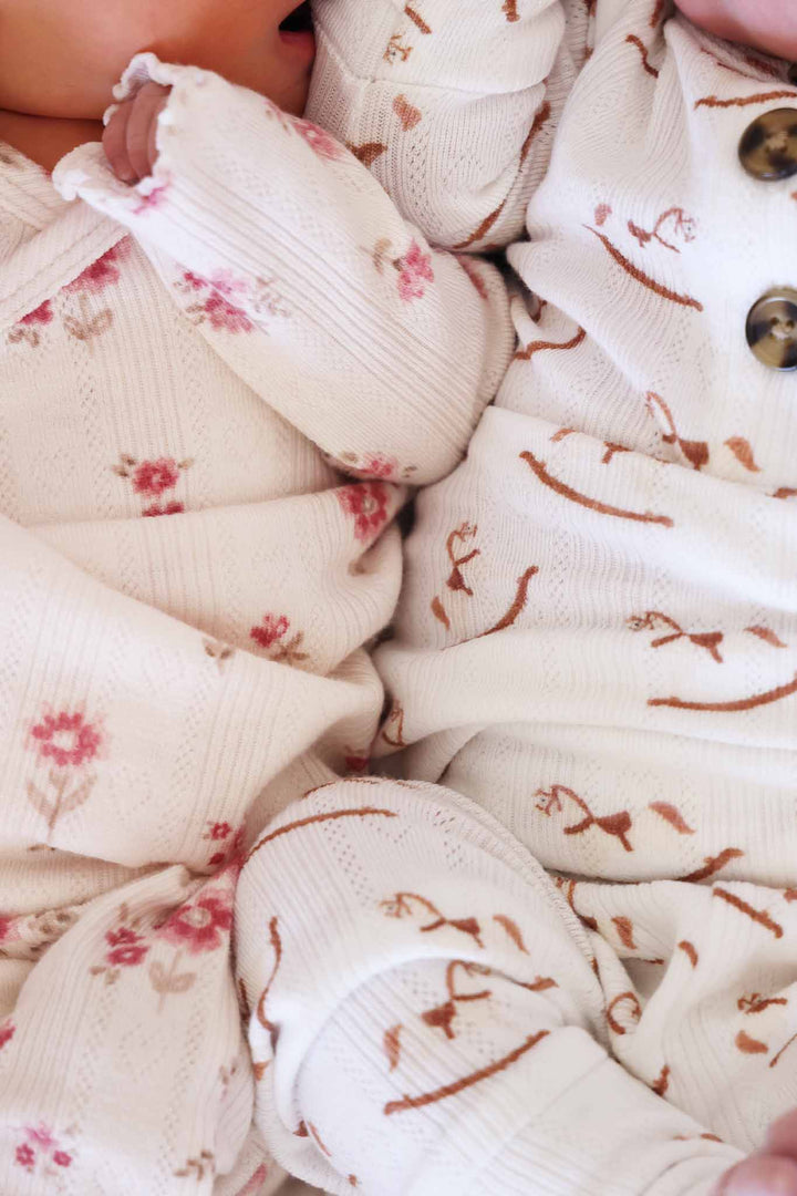 closeup of pointelle two piece crossover sets for babies 