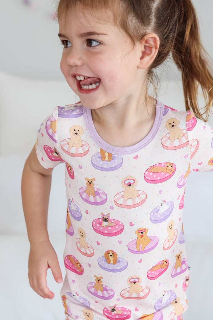 girl with tongue sticking out wearing the poolside pups two piece pajama set