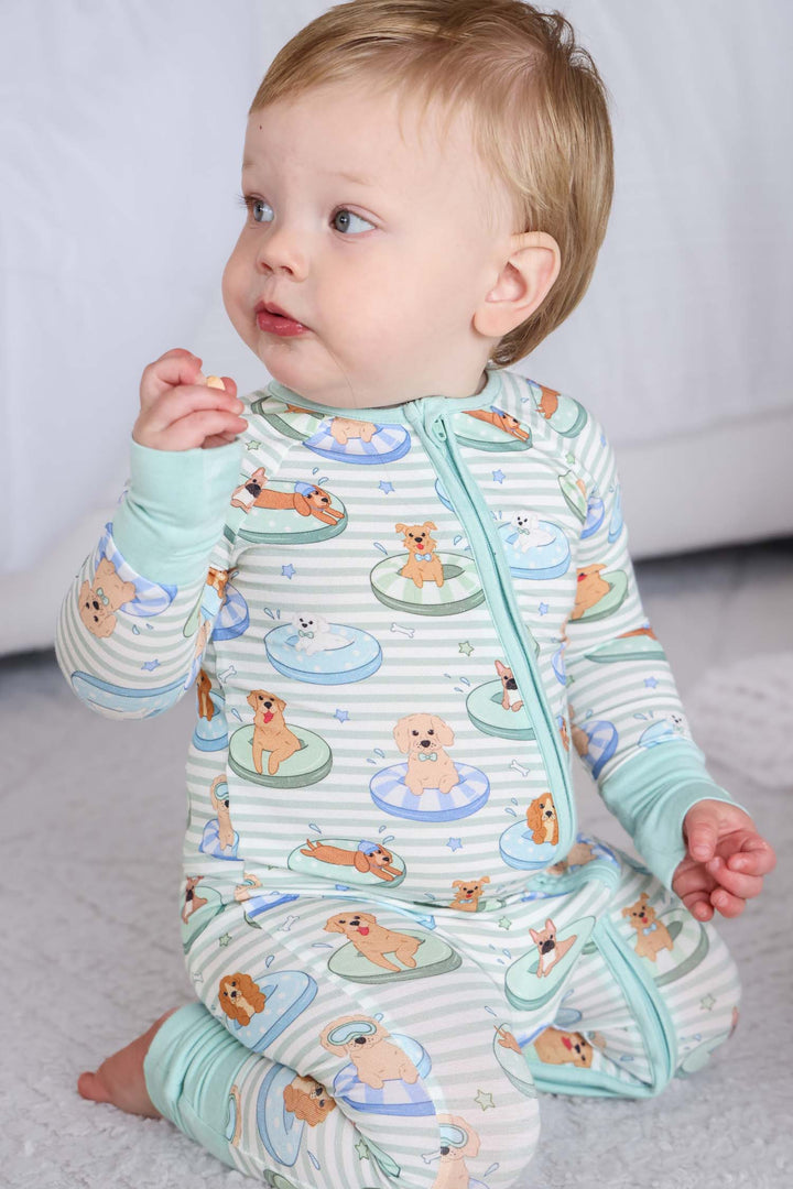 kneeling baby boy in poolside pups bamboo viscose pajama romper 
