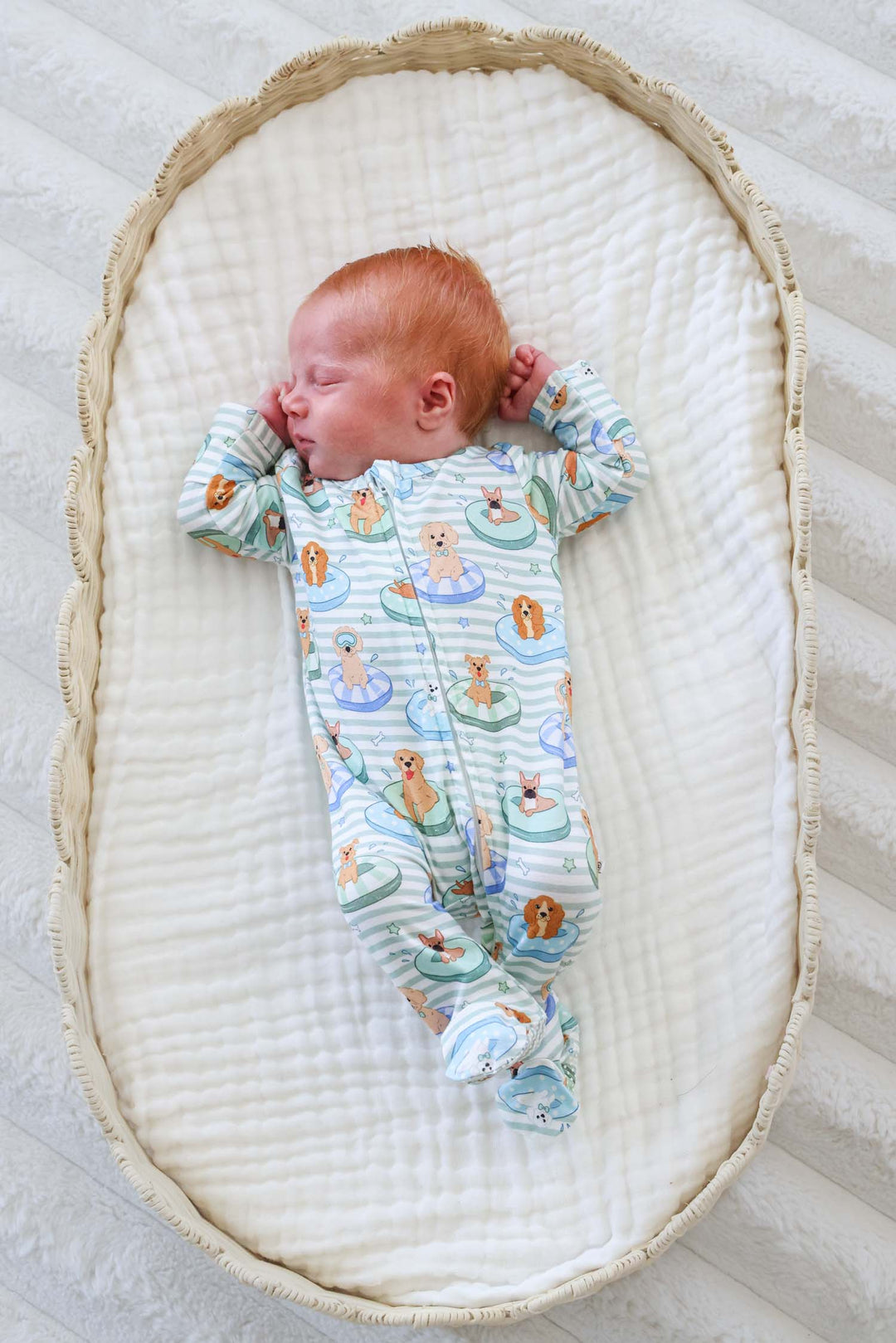 baby boy in lounger in poolside pups footie