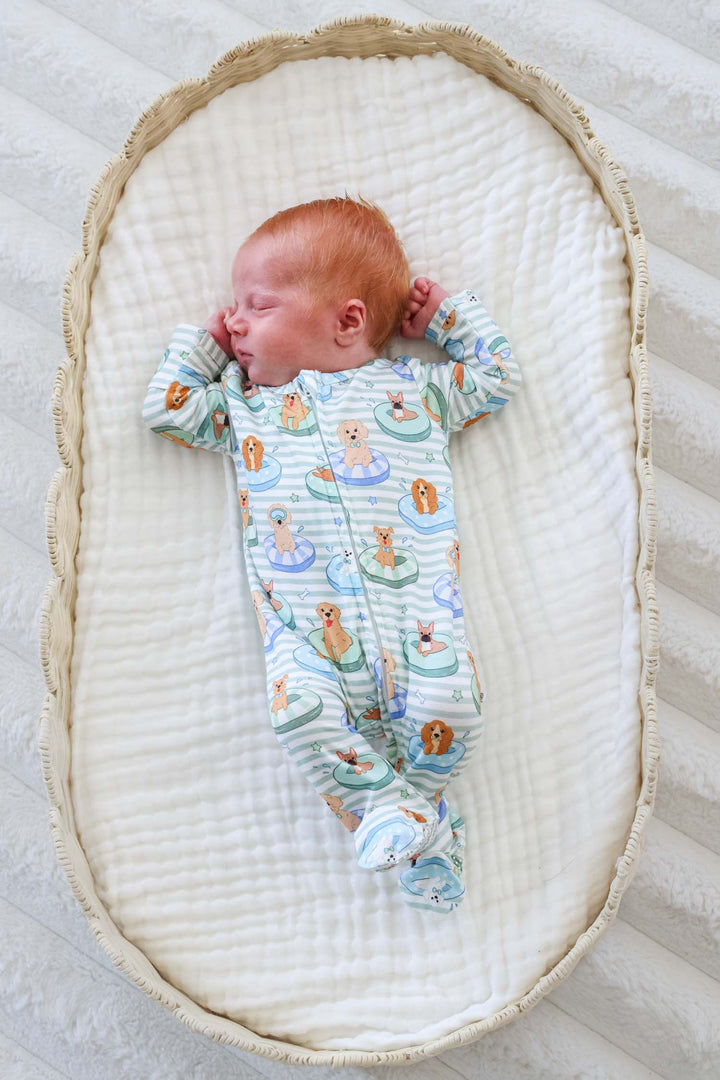 baby boy in lounger in poolside pups footie