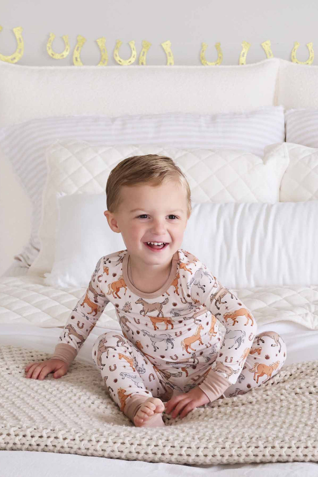 boy's two piece pajama set with ponies, horses, and horseshoes print - caden lane