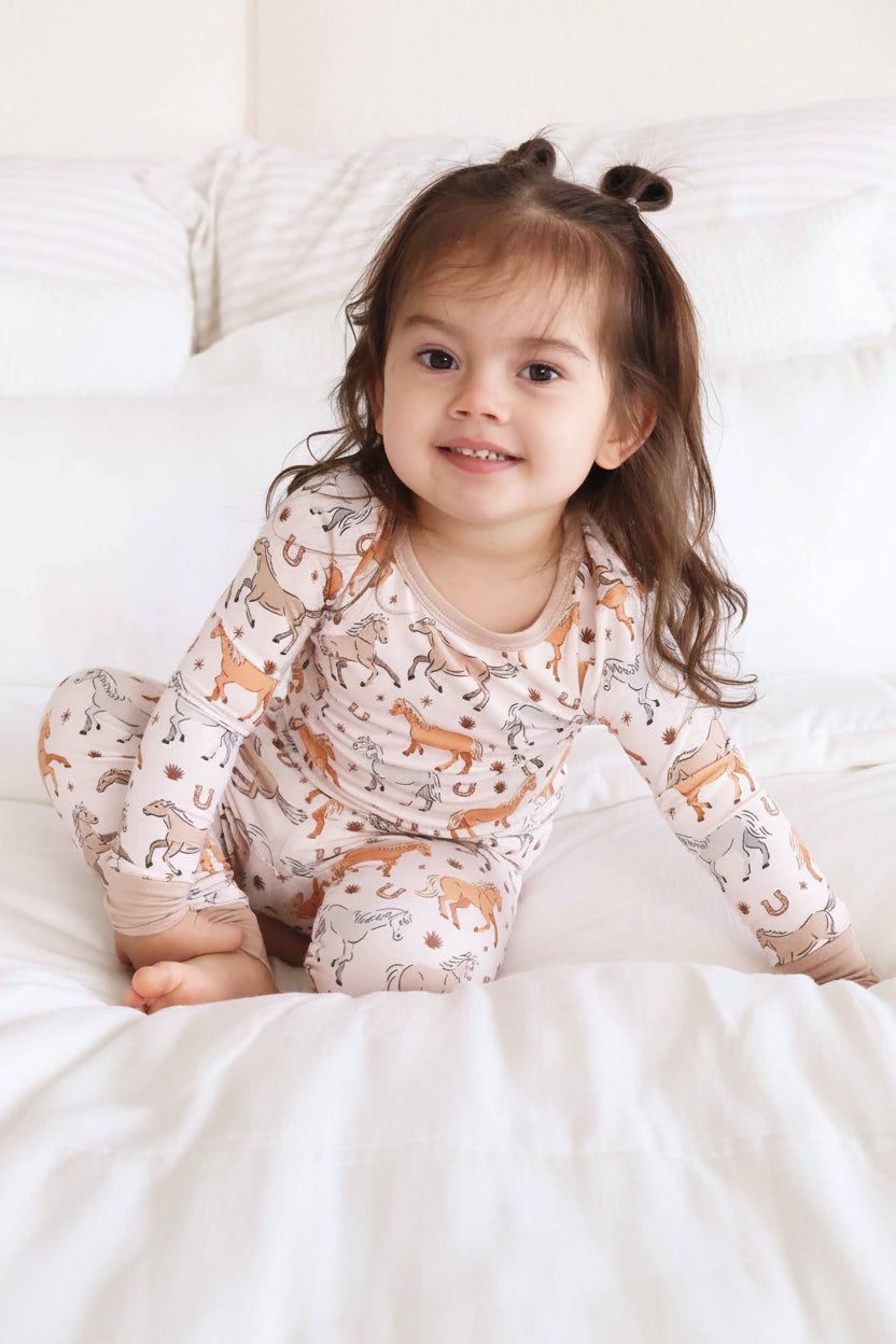 girl's two piece pajama set with ponies, horses, and horseshoes print - caden lane