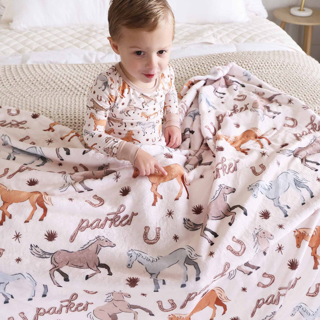 personalized kids blanket with ponies, horses, and horseshoes print - caden lane