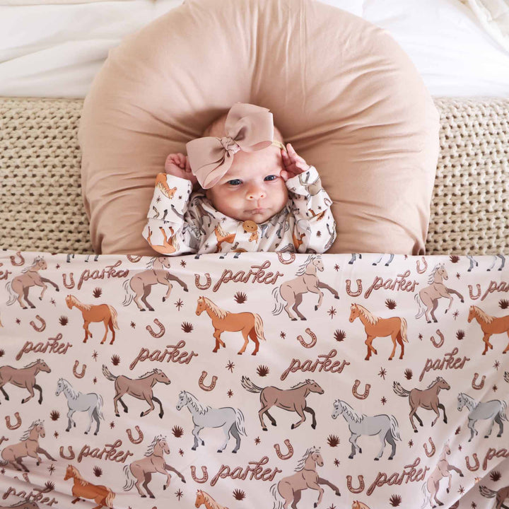 newborn personalized swaddle blanket with ponies and horses print - caden lane