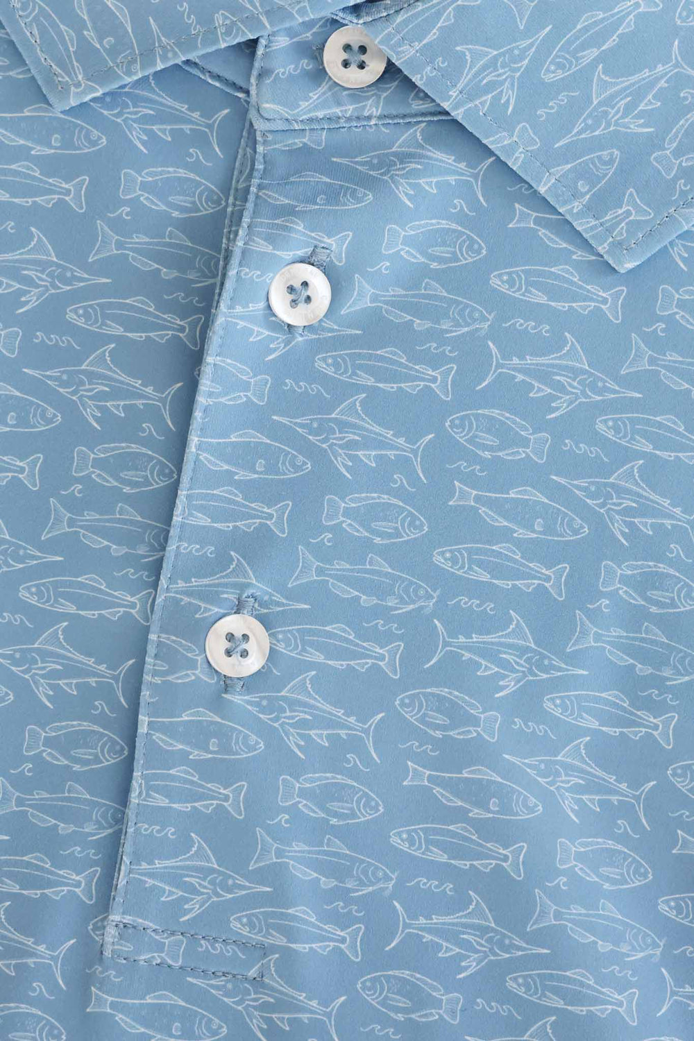 closeup of fishing themed polo shirt 