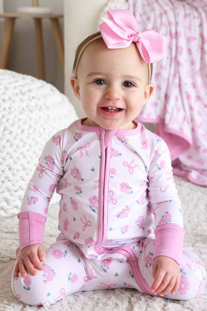 kneeling baby girl in pink ribbon and roses convertible zip romper pajama 