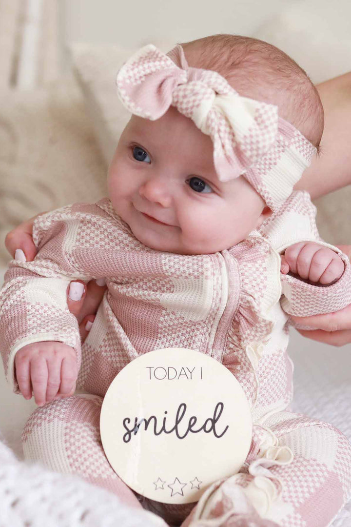 pink check ruffle footie for babies with full length zipper 