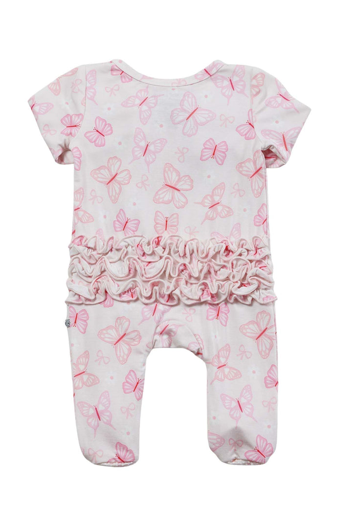 Ruffle Zipper Footie in Blooming Butterflies print - overhead view of newborn on pink satin with stuffed bunny, showing the full footie with bow headband and footed bottom detail