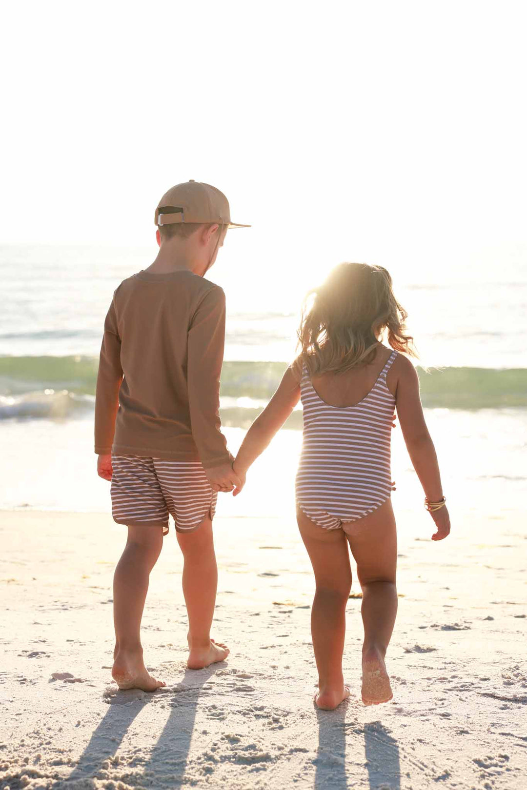 sibling matching striped swimsuits 