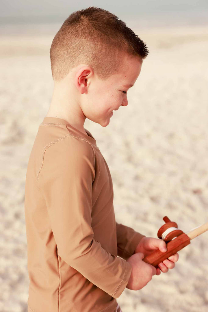 side view of sandy mocha long sleeve rash guard shirt for boys 
