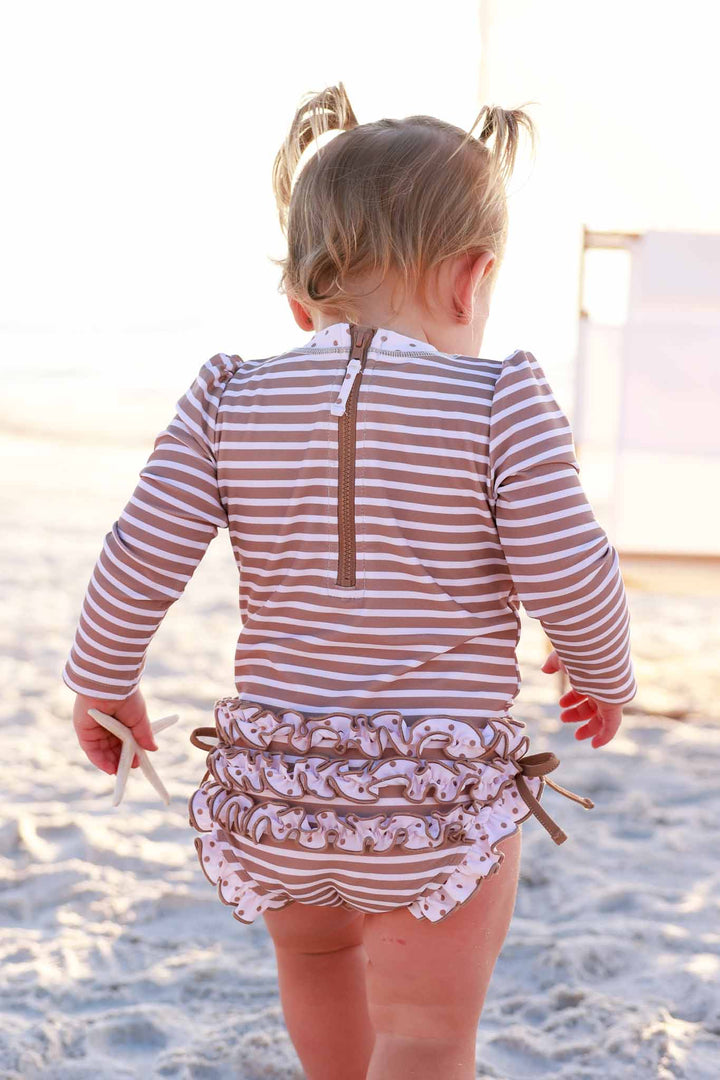 sandy stripes ruffle bottom rash guard romper made with upf 50+ fabric 