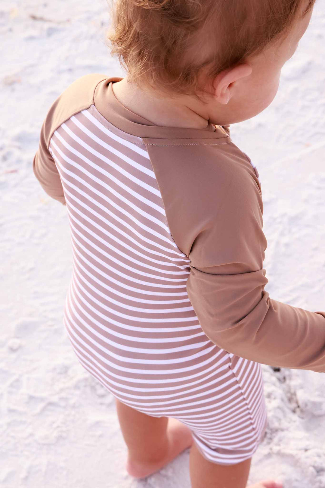 closeup of sandy stripes long sleeve rash guard shortie romper 
