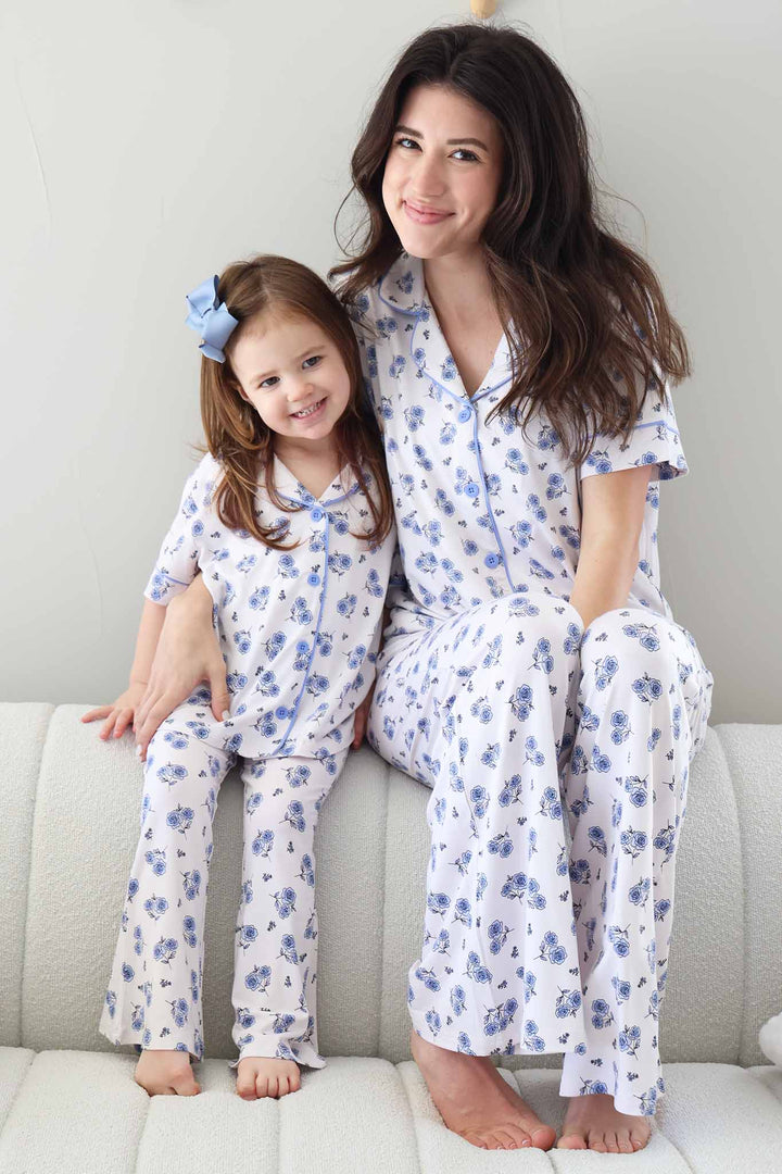 mom and daughter sitting together on couch in blue rose collared button up short sleeve flare lounge sets 