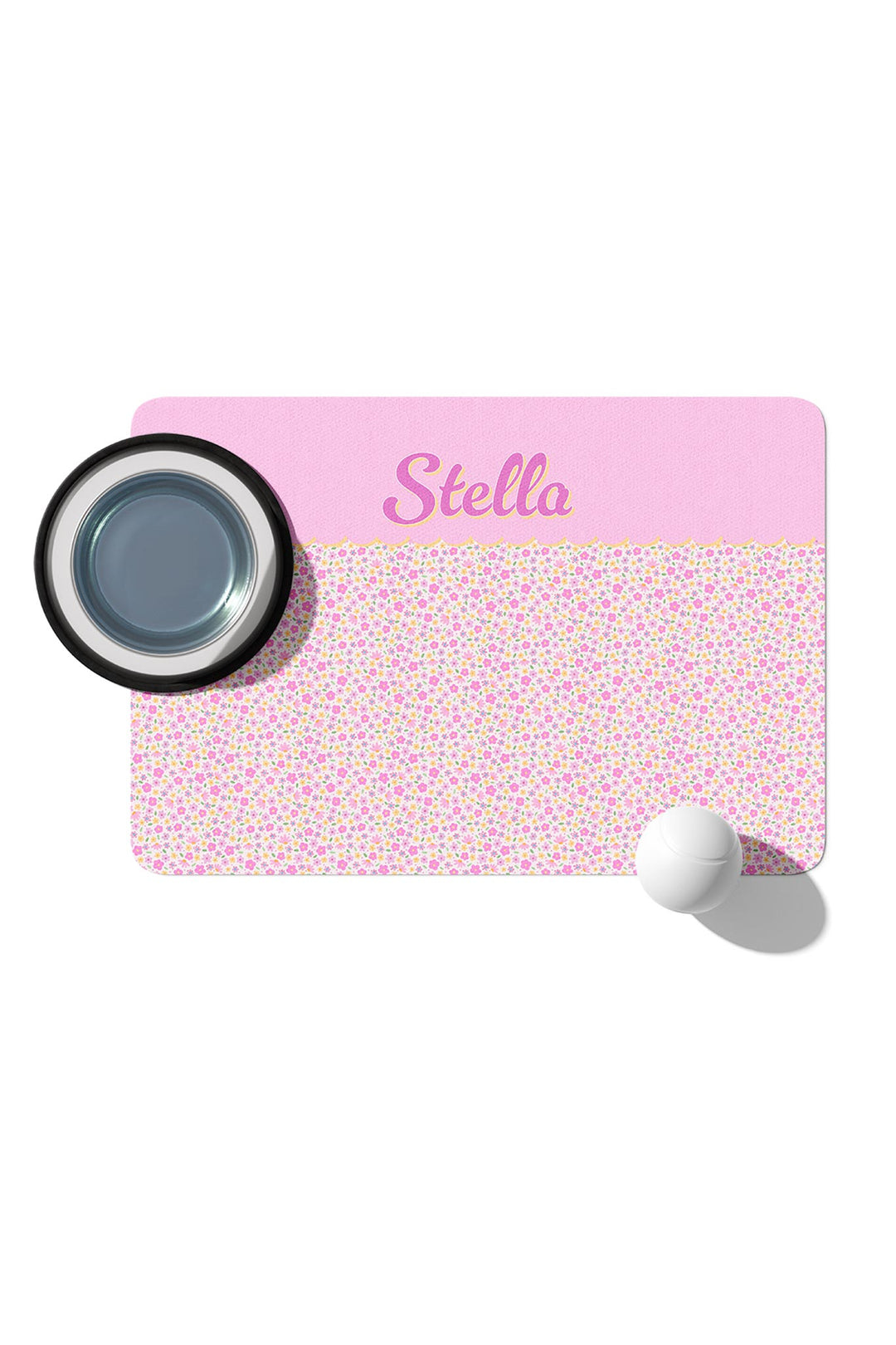 Personalized pet placemat in Scattered Blooms print with pink top panel featuring pet name in script, shown with stainless steel pet bowl
