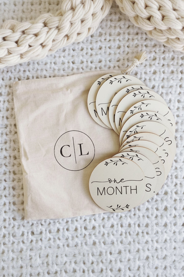 milestone wood circle announcement with months for babies 