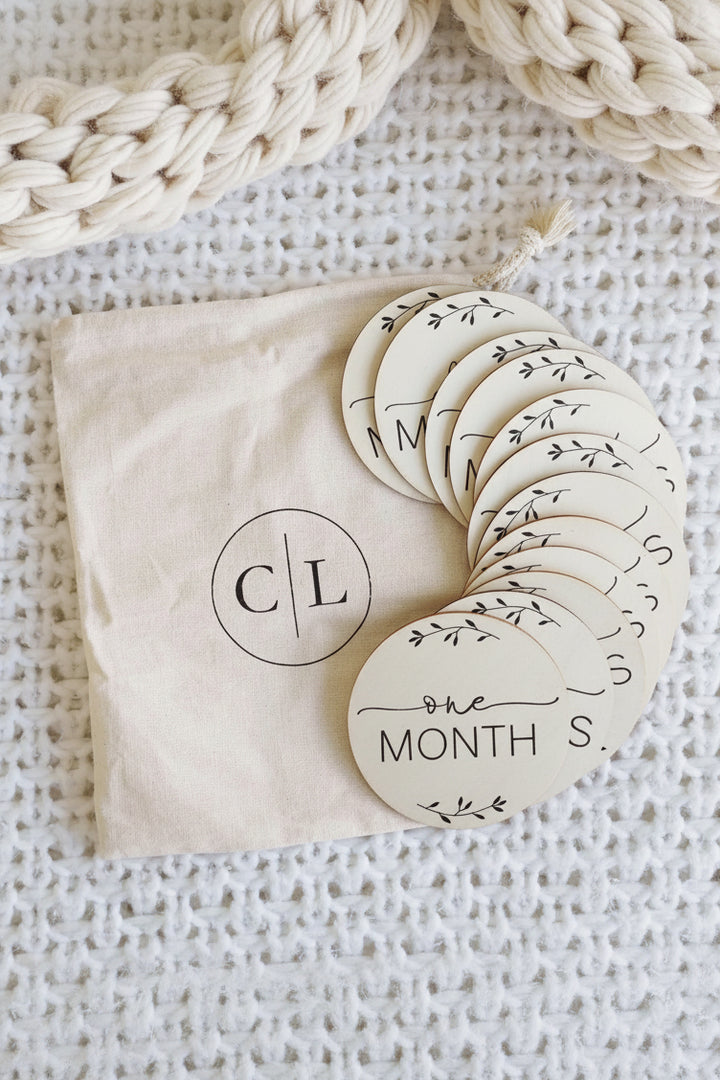 milestone wood circle announcement with months for babies 