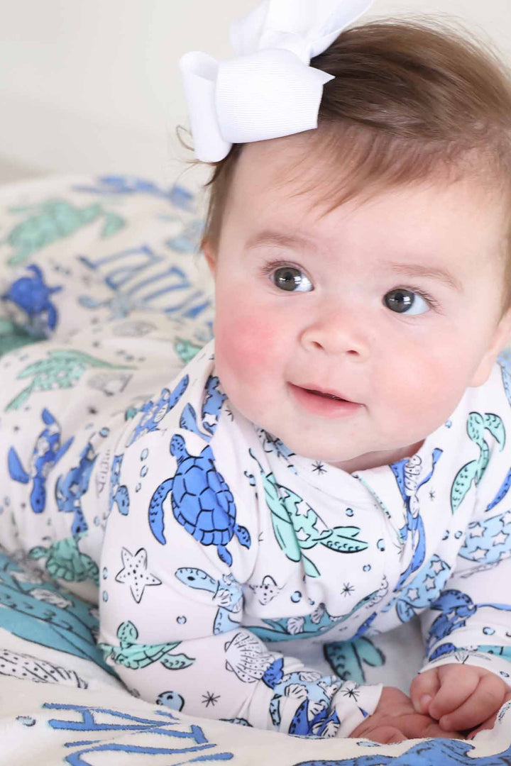 blue and green turtle baby footie