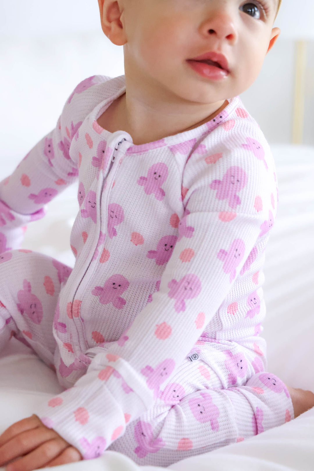 close-up of sea snuggles bamboo waffle convertible zip romper showing zip detail and girly octopus waffle print