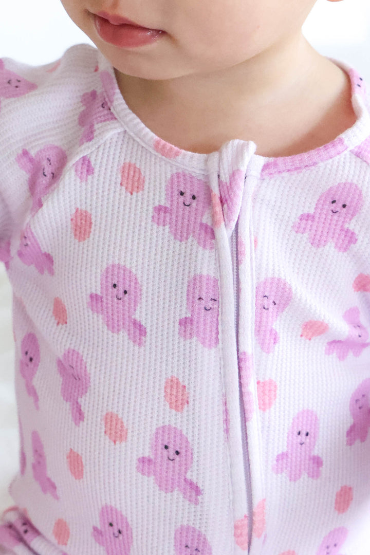 close-up of neckline and zip on sea snuggles bamboo waffle convertible zip romper showing girly octopus print detail