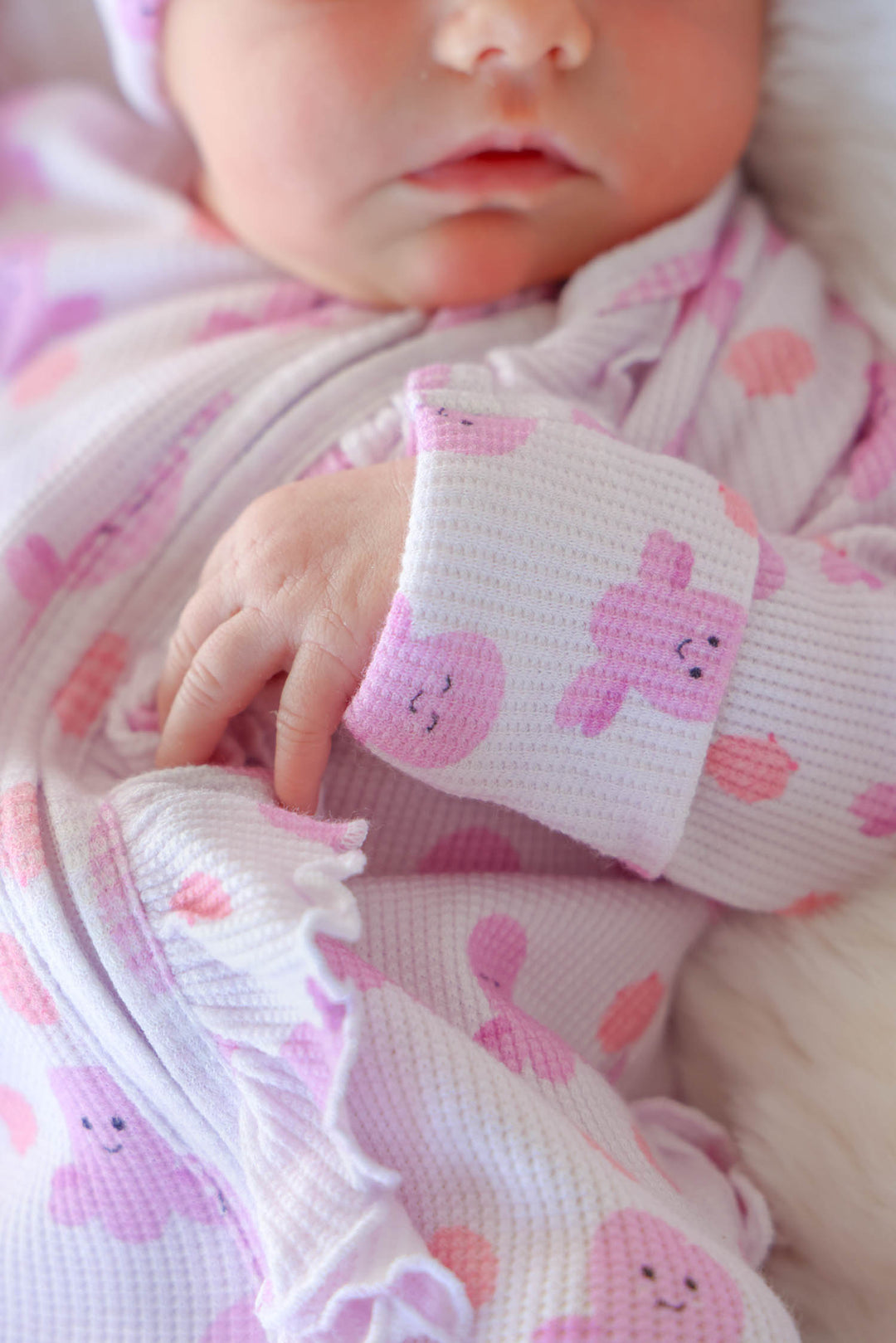 close-up of baby's wrist cuff showing bamboo waffle texture and sea snuggles girly octopus print