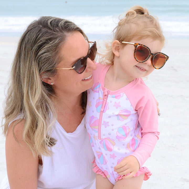 long sleeve rash guard romper with front zipper and seashells pink and purple 