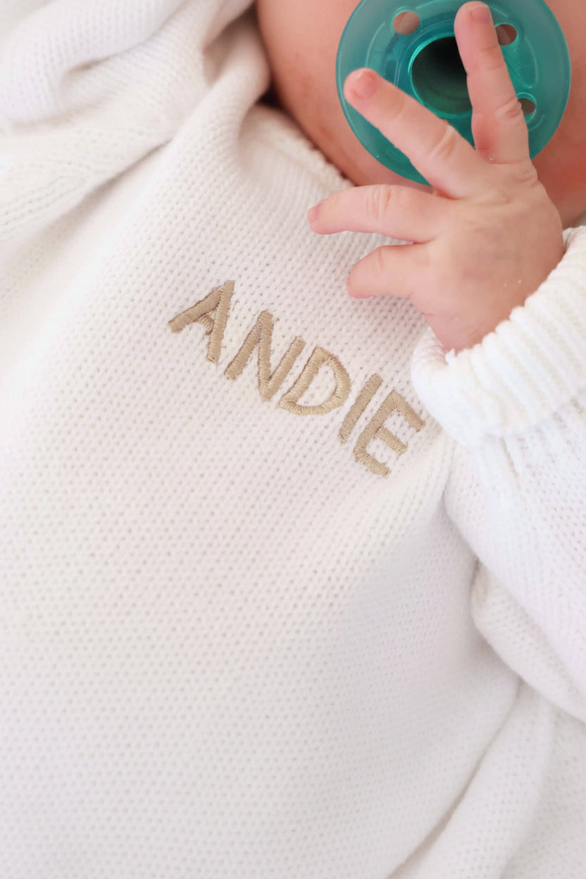 white personalized sweater romper for babies embroidered with name in tan thread