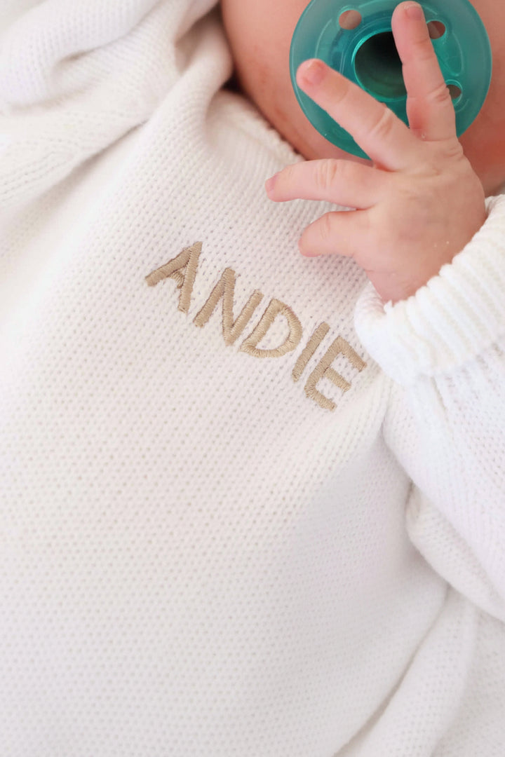 white personalized sweater romper for babies embroidered with name in tan thread