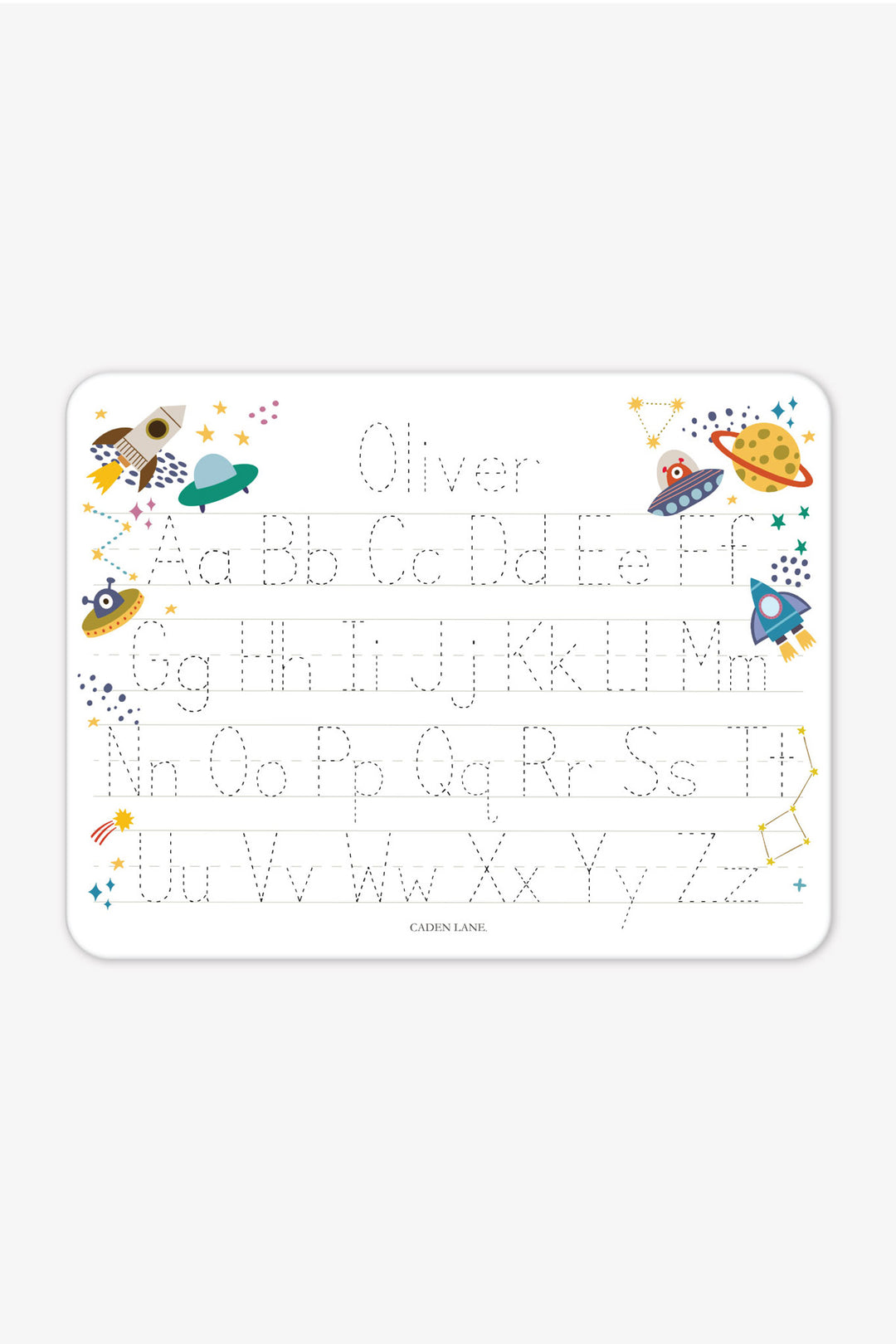 Flat lay of a personalized Caden Lane Star Explorer alphabet whiteboard, showing rockets, UFOs, and planets with tracing letters and custom name