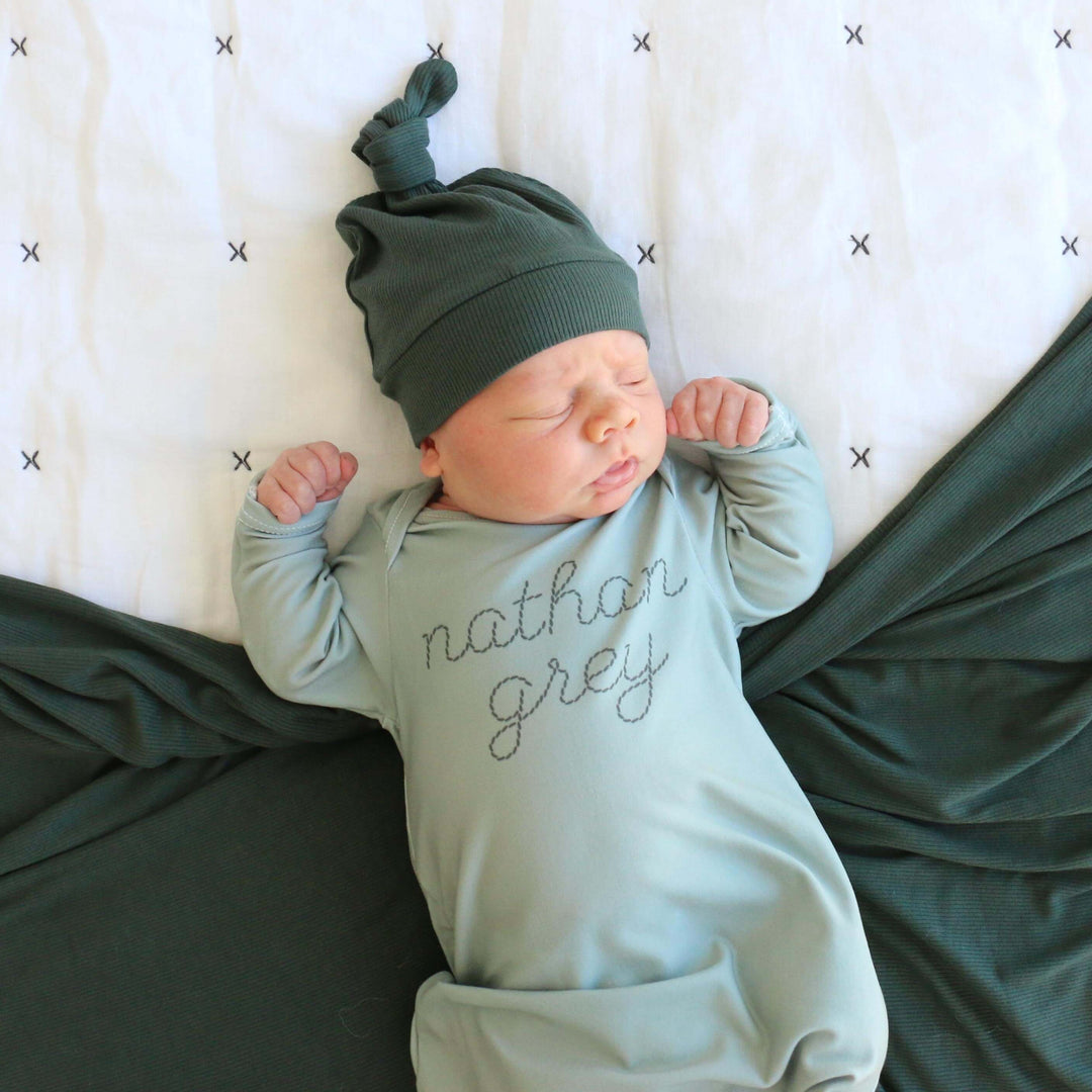 green stitched knot gown for baby