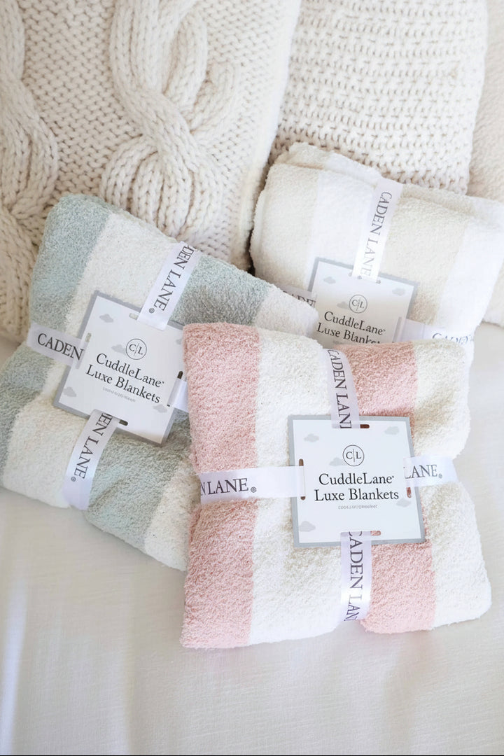 group of striped microfiber blankets in sage, rose and toffee