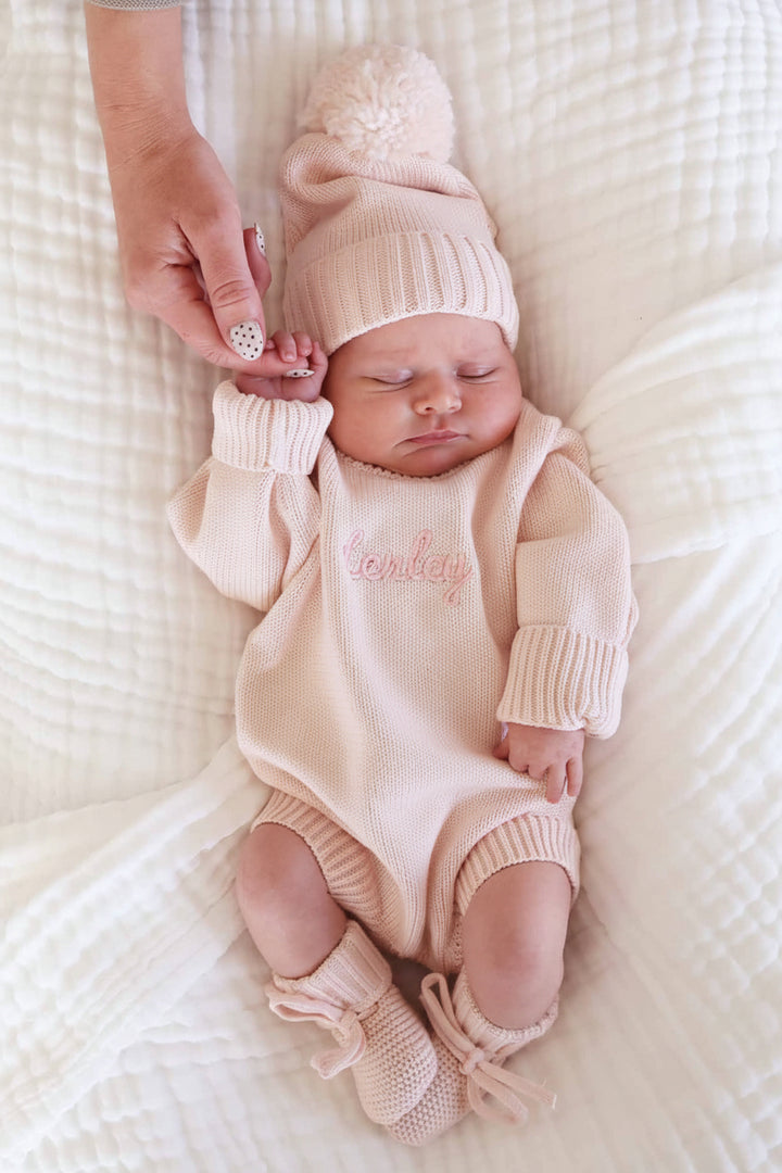 tea rose long sleeve knit sweater romper for baby girls with matching pom pom beanie and knit booties 