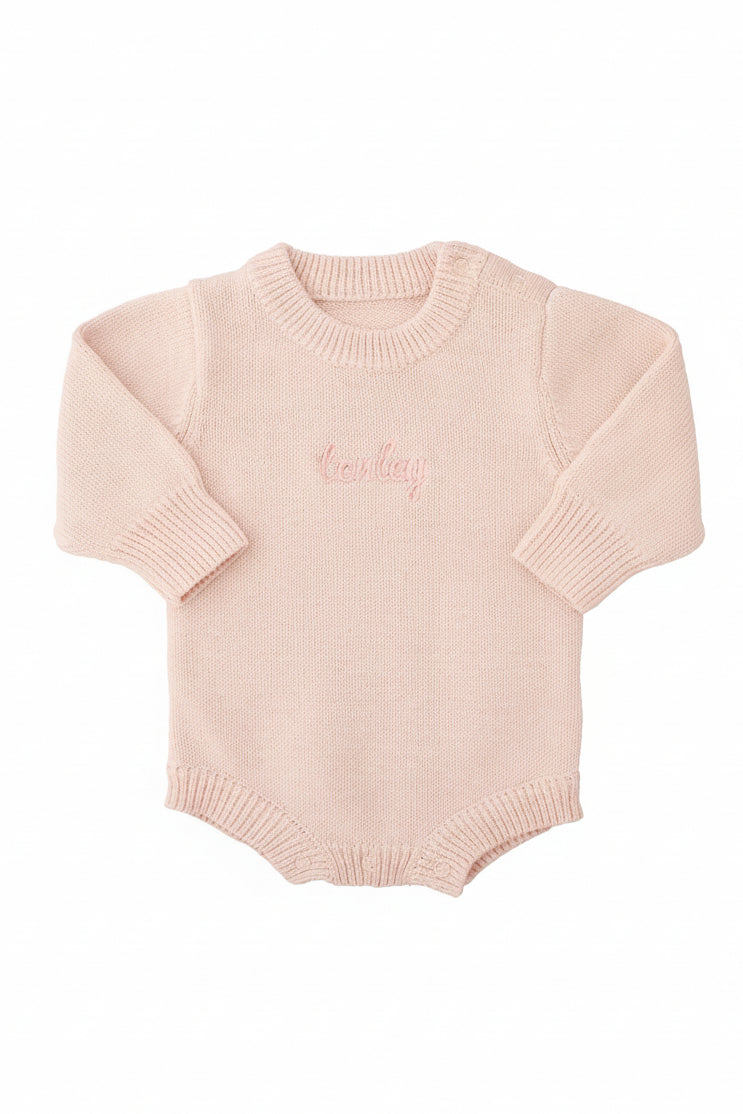 light pink embroidered long sleeve knit sweater romper for babies with pink thread and script font 